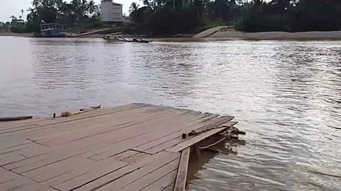 Wooden Damaged Dock on Brown River in Kalimantan Indonesia Stock Footage 340373673