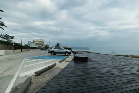 Wooden Decked Coastline Walkway Next To Car Park - Cloudy Morning Stock Footage