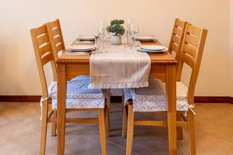 Wooden dining table set for four, green bonsai Stock Photos