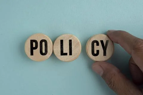 Wooden disk with the word policy. basic concepts or organizational policies. Stock Photos