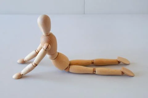 Wooden doll as a model for exercising in a healthy life Stock Photos
