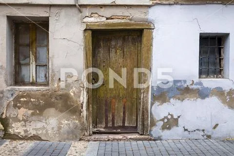 Wooden door and weathered walls on a house,Segovia, Castile and Leon, Spain Stock Photos