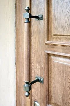 Wooden door with forged elements selective focus on brown old wooden door wit Stock Photos