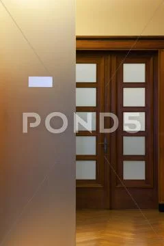 Wooden door with glass and plate in a respectable office Stock Photos