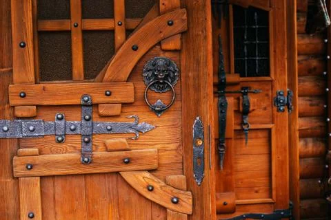 Wooden door with metal antiquity forging Stock Photos
