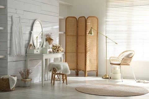 Wooden dressing table with decorative elements and makeup products in room. I Stock Photos