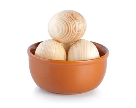 Wooden easter eggs on a plate Stock Photos