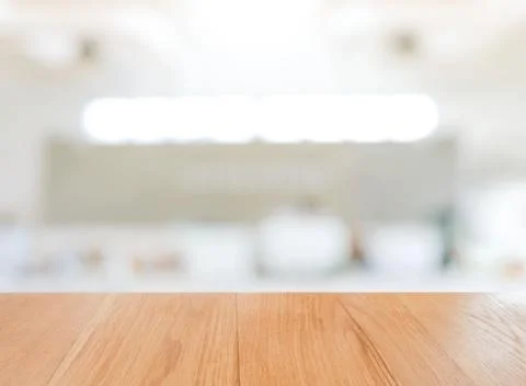 Wooden empty board table in front of white blurred background wallpaper Stock Photos