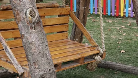 Wooden empty swing in the garden Video stock 171815101
