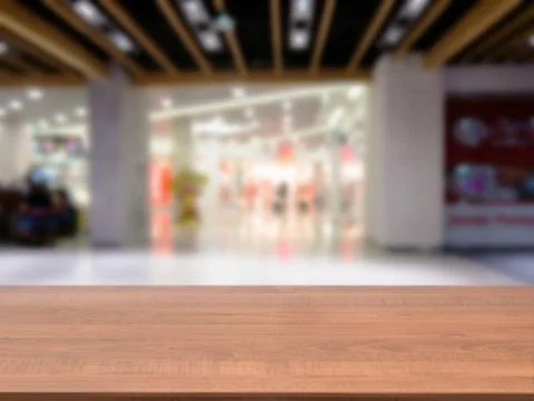 Wooden empty table in front of blurred mall 스톡 사진