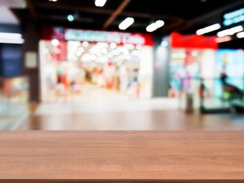 Wooden empty table in front of blurred mall 스톡 사진
