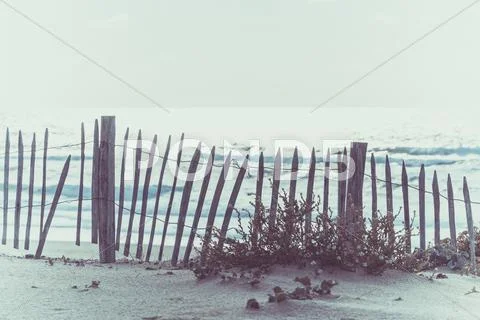 Wooden fence on Atlantic beach in France Stock Photos