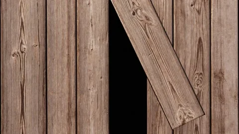 In a wooden fence, one board is pushed back and a passage is formed. Stock Footage 166375923
