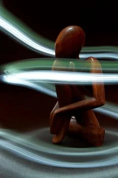 Wooden figure surrounded by light Stock Illustration