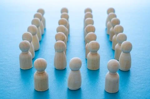 Wooden figures, arranged in multiple rows. Stock Photos