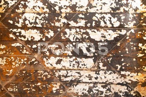 Wooden floor with peeling old brown paint Stock Photos