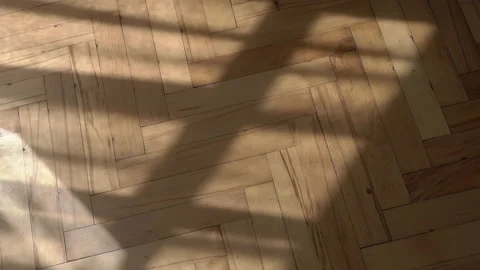 Wooden floor with shadows from the window background. Wooden parquet floor in Stock Footage 153899499
