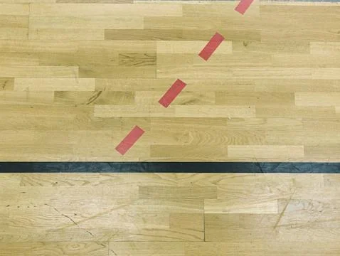 Wooden floor in sporting hall with solid and dotted lines.  Light reflection Stock Photos
