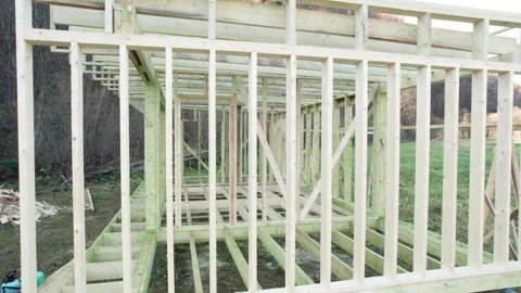 Wooden frame house under construction from drone view. Timber structure Stock Footage 346541117