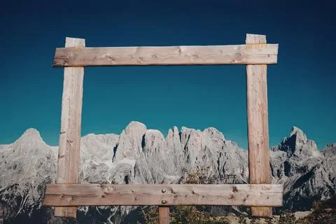 Wooden frame structure with mountain range in the background Stock Photos