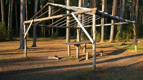 Wooden frame for a tent in a pine forest in autumn sunny warm day. Stock Footage 146360648