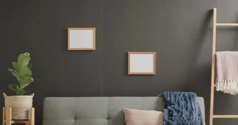 Wooden frames with copy space on white background with plant and sofa against Stock Footage 331208383