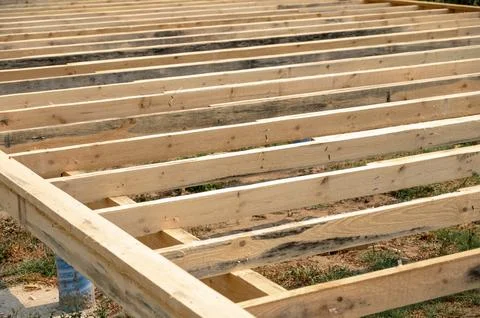 Wooden framework for construction project on grassy ground outdoors Stock Photos