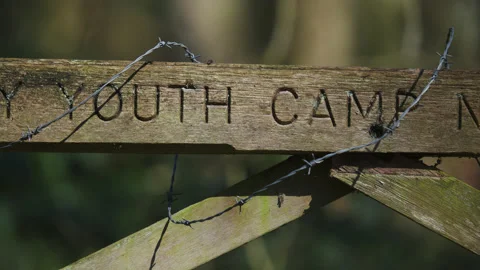 Wooden gate with barbed wire in dappled shade of trees  - close up 2. 4K tripod Stock Footage 177273741