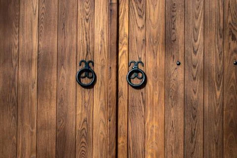 Wooden gate with wrought iron elements close up 写真素材