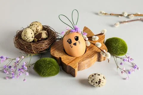 Wooden holder of creative Easter egg with pussy willow branches and flowers o Stock Photos