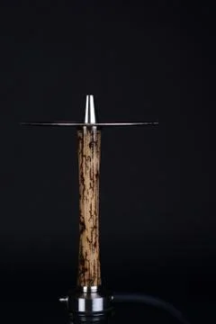 Wooden hookah with lightning patterns and metal elements on a dark background Stock Photos