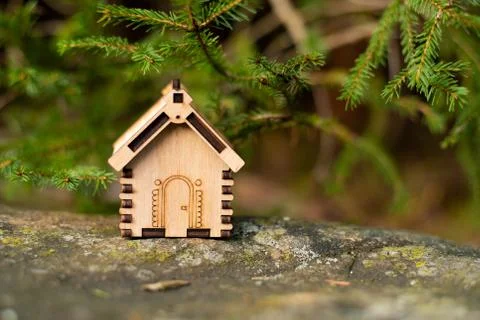 Wooden house model in the forest. concept Stock Photos