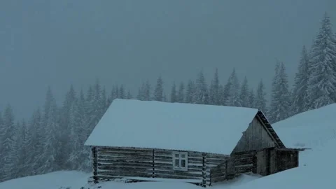 Wooden hut in the middle of a forest snowfall is a severe winter (2) Stock Footage 145698786