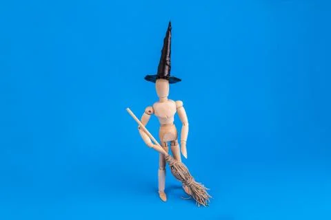 Wooden jointed witch figure standing holding witches broom Stock Photos