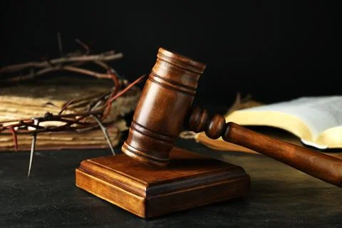 Wooden judge gavel and crown of thorns on black table, closeup Stock Photos