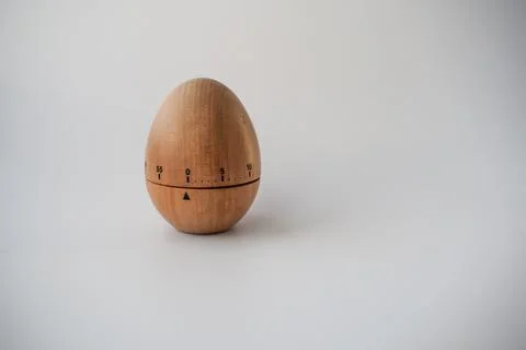 Wooden Kitchen Timer in Egg Shape on White Background Stock Photos