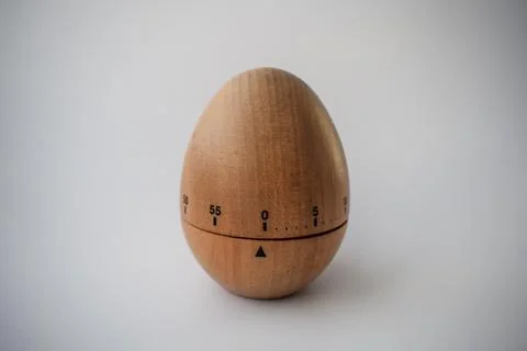 Wooden Kitchen Timer in Egg Shape on White Background Stock Photos