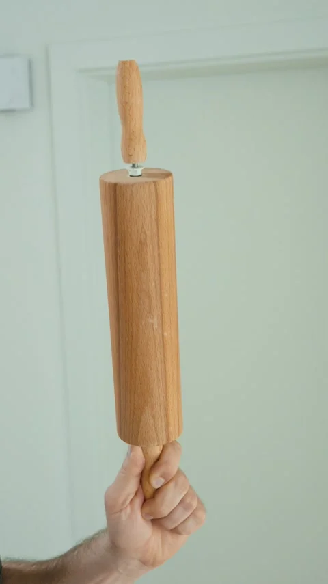 Wooden kitchen tools held in hand Stock Footage 335998092