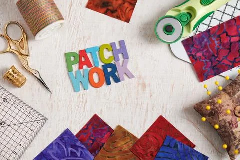 Wooden letters, consisting to the word patchwork surrounded by accessories .. Stock Photos