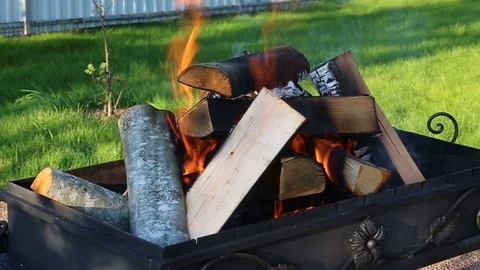 Wooden logs burning for coals in brazier grill Stock Footage 99282935