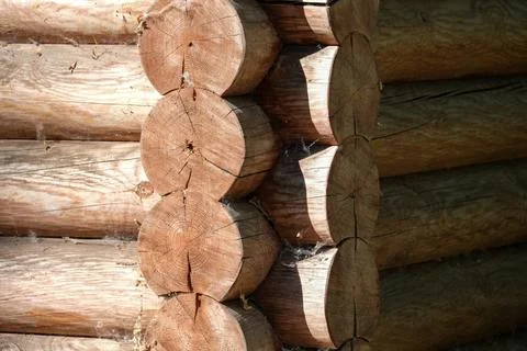 Wooden logs create unique patterns in a rustic cabin wall Stock Photos