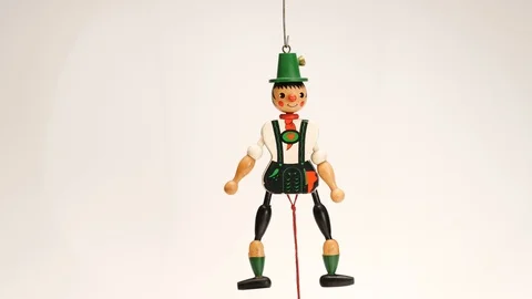 WOODEN MAN TOY DANCING AS STRINGS ARE PULLED  Stock Footage 121266160