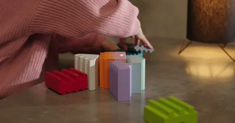 Wooden multi-colored bricks on the table. The child collects colorful wooden cub Stock Footage 277480974
