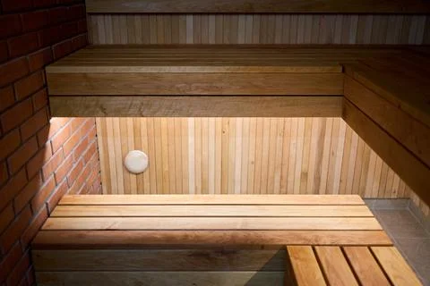 Wooden multi level sauna floating benches features built-in under-bench LED l Stock Photos