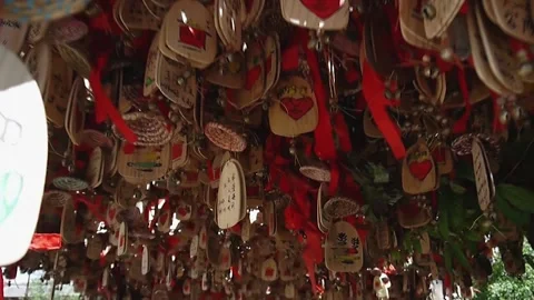 Wooden notes with Chinese characters and red ribbons hanging like decorations 動画素材 135038457