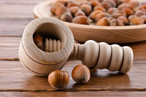 Wooden nutcracker and hazelnuts Stock Photos