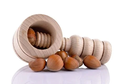 Wooden nutcracker and hazelnuts Stock Photos
