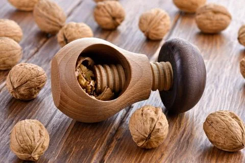 Wooden nutcracker and walnuts Stock Photos