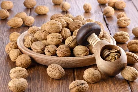 Wooden nutcracker and walnuts Stock Photos