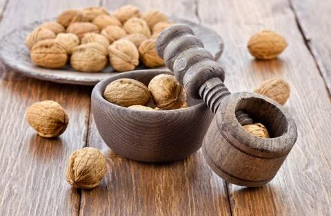 Wooden nutcracker and walnuts Stock Photos